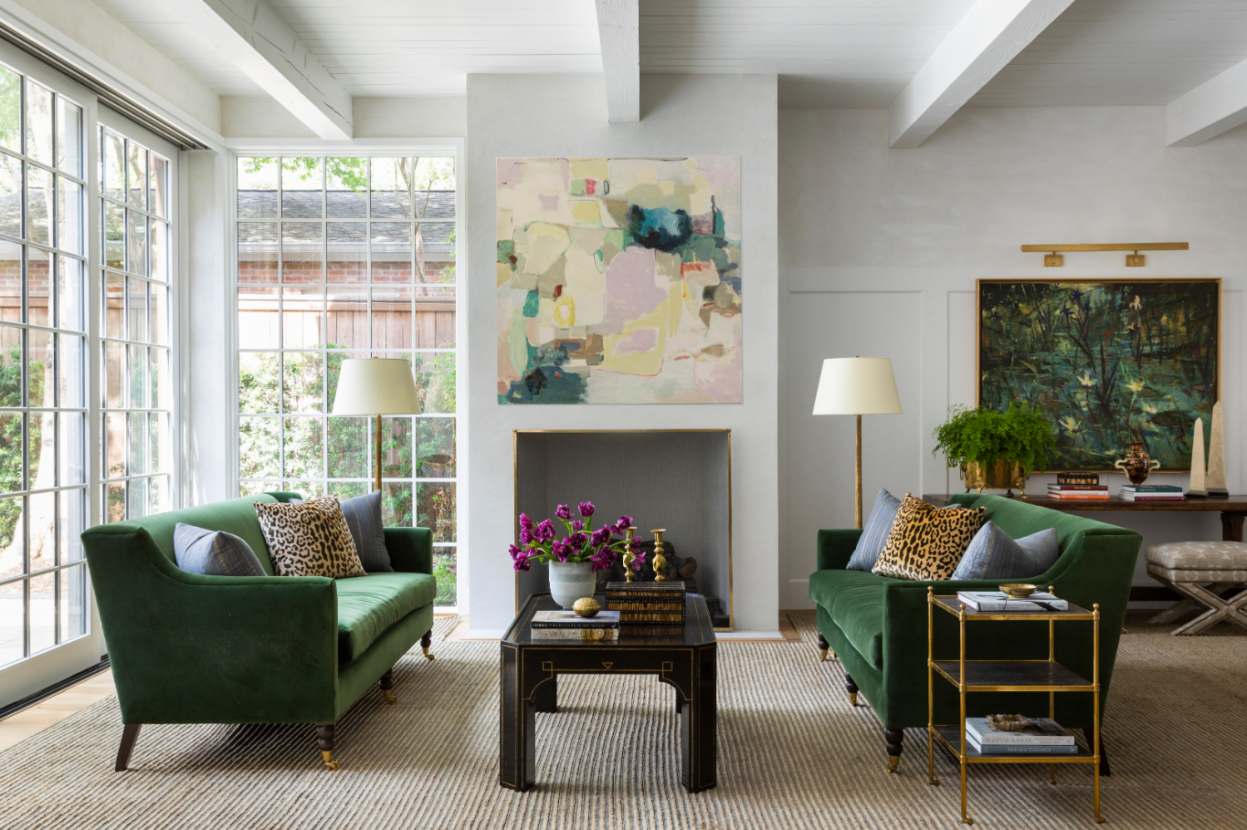 “The living room was so pretty with the light, and the backyard is gorgeous, so we didn’t use and window treatmants,” Epley says. The art pieces, including Terrell James’s Finding Home and John Alexander’s Blue Irises (On My Pond) were curated by Epley’s firm, C2 Art Advisors. JULIE SOEFER